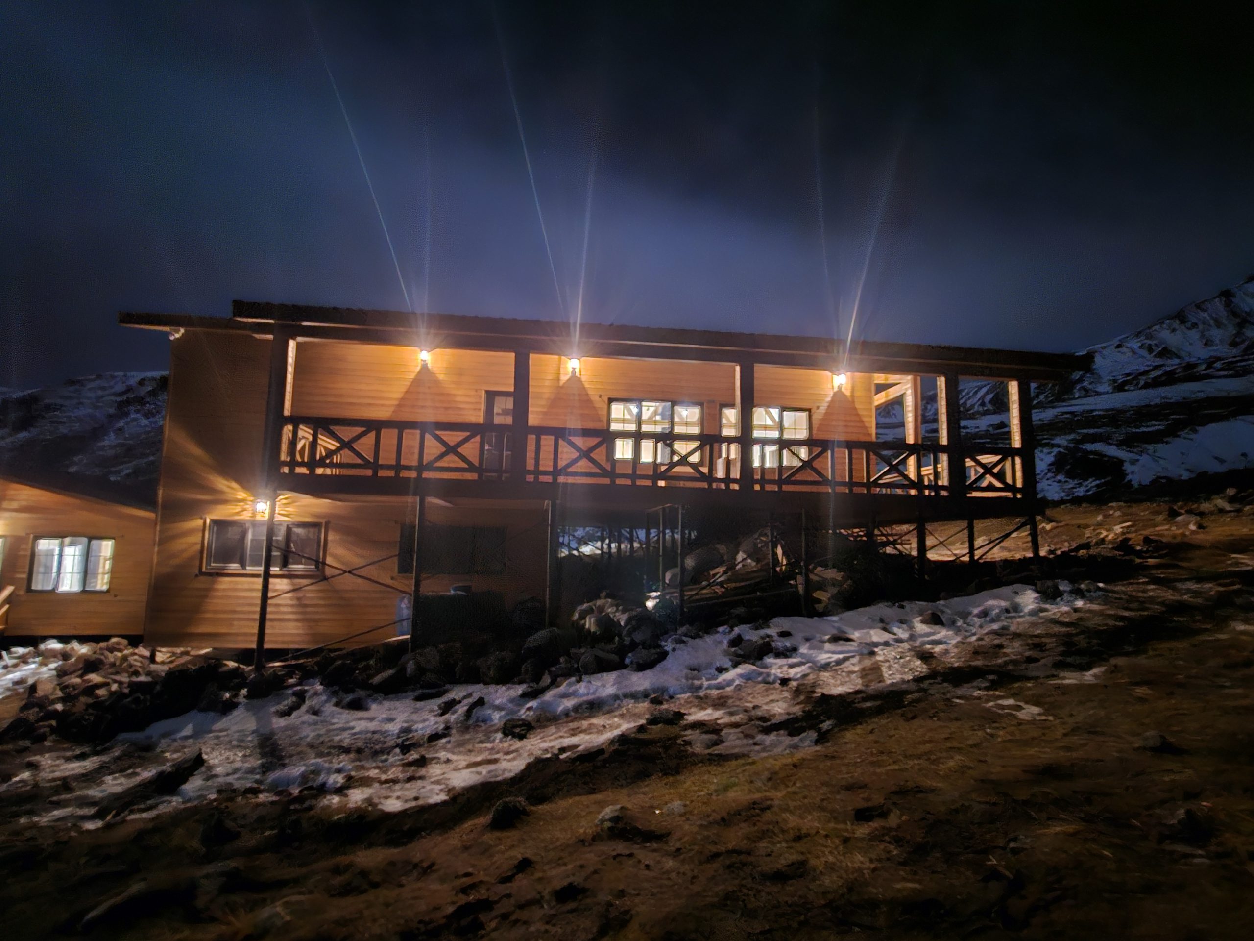 Alpine hut deka at night under mount kazbeg in Georgia